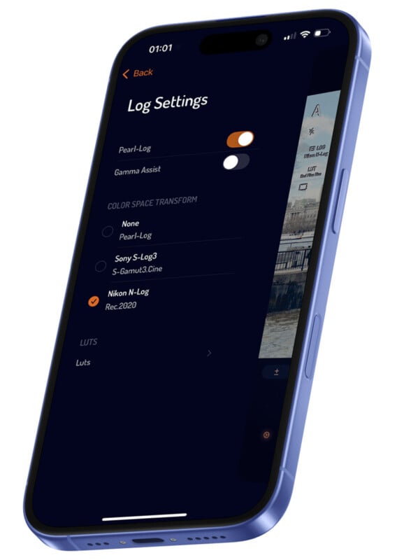 A smartphone displaying a "Log Settings" screen from a camera app. Options include adjustments for Gamma Assist and Color Space Transform with selections like Pearl-Log and Nikon N-Log. The phone is tilted against a white background.