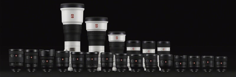 A collection of various camera lenses arranged in rows, featuring a mix of large white lenses and smaller black lenses. They are displayed against a black background, showcasing different shapes and sizes.