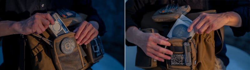 A person is placing a gray device inside a tan messenger bag. The bag has multiple compartments and a patch with a circular design. The scene is set against a dimly lit background.