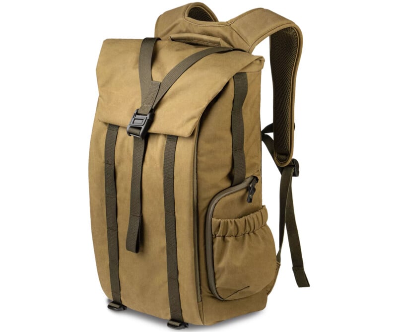 A tan backpack with a top flap secured by a black buckle strap. It has two vertical front straps, side pockets, and padded shoulder straps. The design is minimalist and functional.