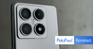 Close-up of a smartphone's quad-camera setup with a Leica logo, captured on a silver device. The image includes a "PetaPixel Reviews" banner in the lower right corner.