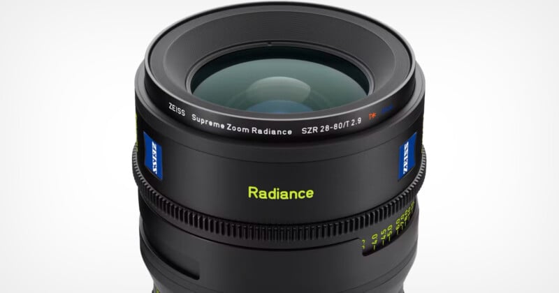 Close-up image of a Zeiss Supreme Zoom Radiance camera lens with specifications SZR 28-80/T2.9. The lens features a sleek black finish and prominently displays the Zeiss logo and "Radiance" branding in yellow text.