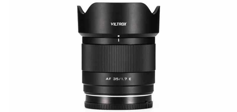 A black Viltrox camera lens with a wide aperture of AF 35/1.7 E, featuring a textured focus ring and lens hood, is shown against a white background.