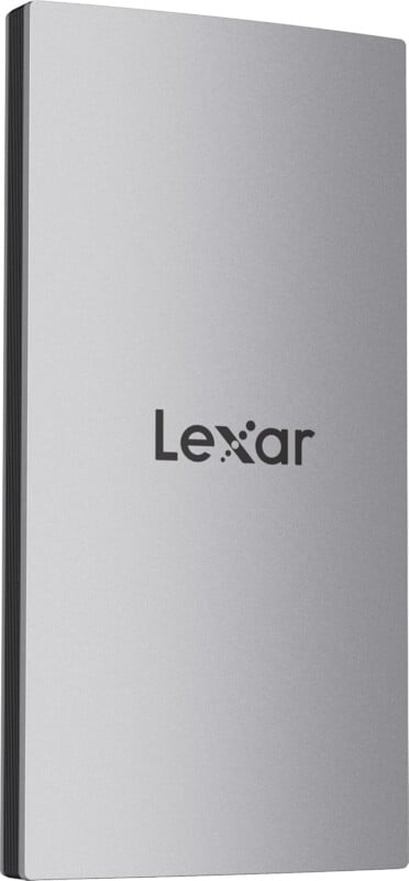 A silver Lexar portable external hard drive with the brand name "Lexar" printed in black on the front. The hard drive has a sleek, minimalist design with a smooth surface.