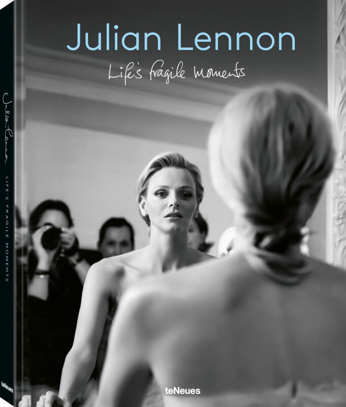 Cover of "Life's Fragile Moments" by Julian Lennon. A black-and-white image shows a woman looking at herself in a mirror, with her back to the camera. Photographers are visible in the background. The title and author's name are in the foreground.