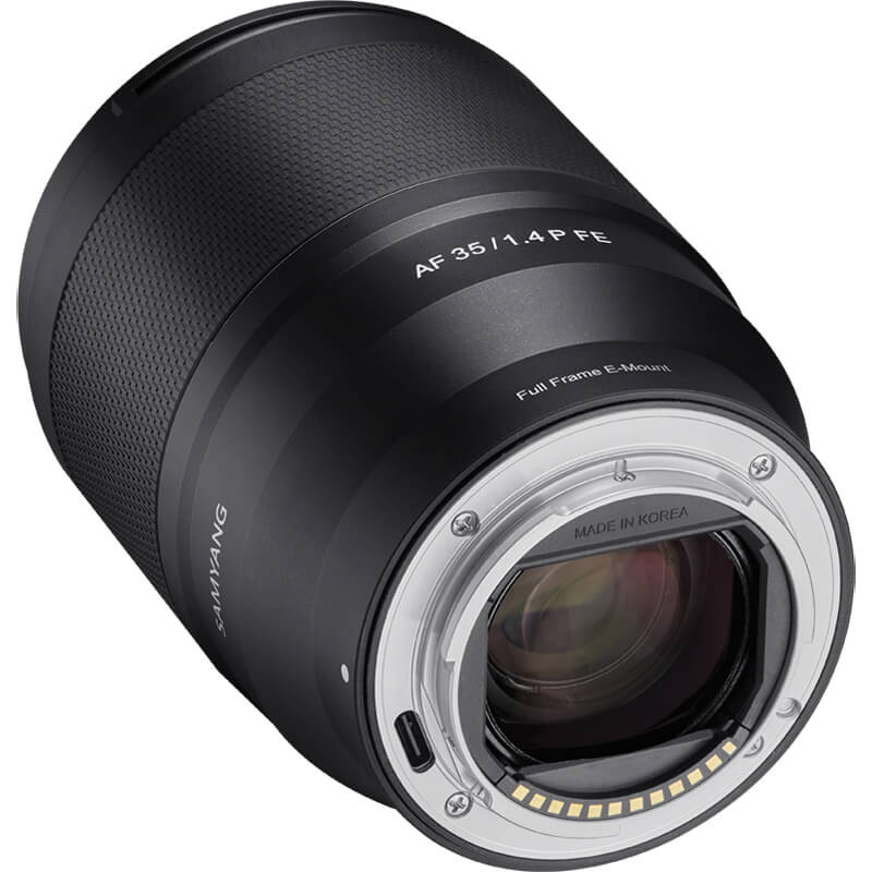 A black camera lens with markings for "AF 35/1.4 FE" and "Full Frame E-Mount." The lens features a textured grip and metallic accents, and is labeled "Made in Korea.