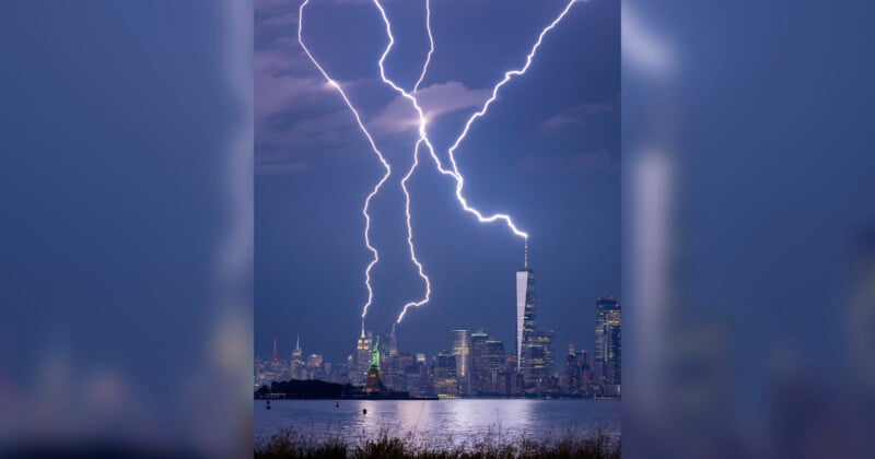 A dramatic scene of multiple lightning bolts striking behind a city skyline at night. Prominent buildings are visible, and the sky is dark and cloudy, with bright lightning illuminating the scene.