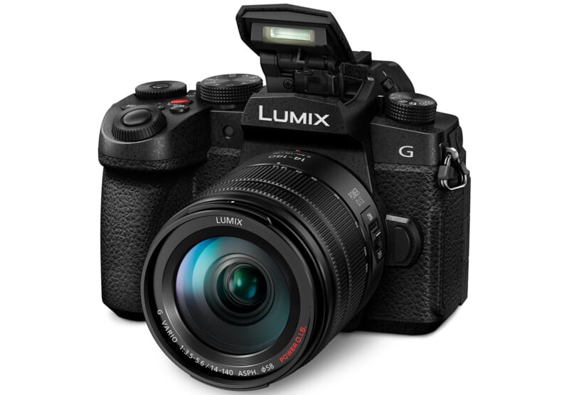 A black LUMIX digital camera with a large lens and an additional flash. Glasses are labeled with "Figures 14-140" and it has transparent and transparent rings. The camera has a handle and various buttons and dials to adjust settings.