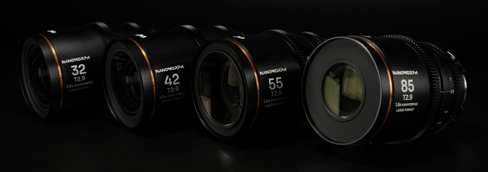 A row of Nanomorph lenses with focal lengths of 32mm, 42mm, 55mm, and 85mm, all featuring an aperture of T2.9. The lenses are aligned diagonally against a dark background, showcasing their design and branding.