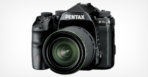 A black Pentax K-1 Mark II DSLR camera with a large lens is displayed on a plain white background. The camera features a textured grip and several control buttons and dials.