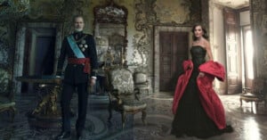 A man in a formal military uniform and a woman in a strapless black gown with a red coat stand in an ornate, elaborately decorated room featuring luxurious furniture and intricate wall designs.