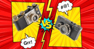 A comic-style image with two vintage cameras facing off against each other, separated by a "VS" in the center. The camera on the left has a speech bubble saying "Grr!" and the one on the right says "#@!". The background is bright red and yellow with black lines.