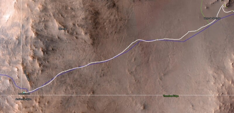 A map showing a detailed terrain with a white and blue path line indicating a route between various labeled locations, including Waypoint 3 and Navidad Slipface, with rocky and sandy areas visible.