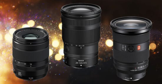 Three camera lenses are displayed against a blurred background of golden lights. Each lens has distinct markings and branding visible.