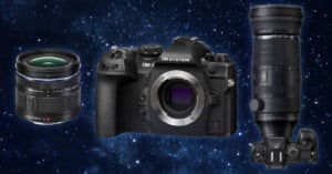 A digital camera and two interchangeable lenses are displayed against a starry space background. The camera has a textured black body, and the lenses vary in size, with one being more compact and the other longer and bulkier.