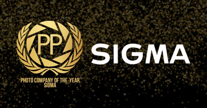 Gold laurel wreath with "PP" inside on a black background. Text reads "PHOTO COMPANY OF THE YEAR SIGMA" next to the Sigman logo. Gold specks scattered around.