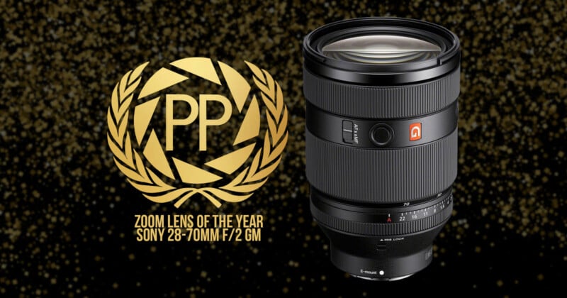 Image of a Sony 28-70mm f/2 GM lens next to a "PP" award emblem with laurel wreath. The text reads "Zoom Lens of the Year" on a glittery black and gold background.