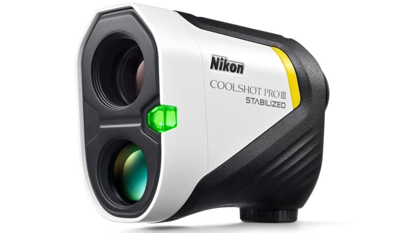 A Nikon CoolShot Pro III Stabilized rangefinder with a white and black body, featuring a green button and dual lenses on the front. The brand name and model are clearly visible on the side.