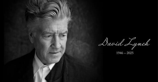 Black and white image of an older man with wavy hair looking down. He wears a suit and white shirt. Text reads "David Lynch 1946 - 2025" in cursive on the right side against a dark background.