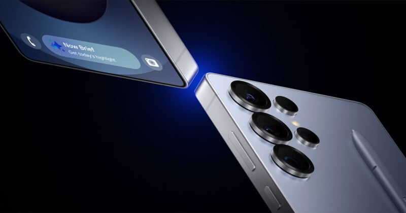 Two sleek smartphones face each other against a dark background, showcasing their edges. One screen displays a message, while the other highlights the camera lenses. A stylus is visible on the side of the second device.