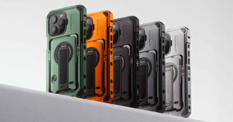 Five rugged phone cases are displayed, standing upright in a row. They come in green, orange, black, and silver-gray colors. The cases feature sturdy designs with integrated stands and branding labeled "KEVLAR" and "KTTEND.