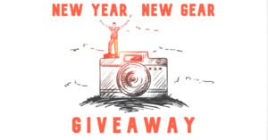 Illustration of a person standing on a large camera with arms raised. Text reads "New Year, New Gear Giveaway." The background is light with sketch-like lines suggesting clouds or mountains.