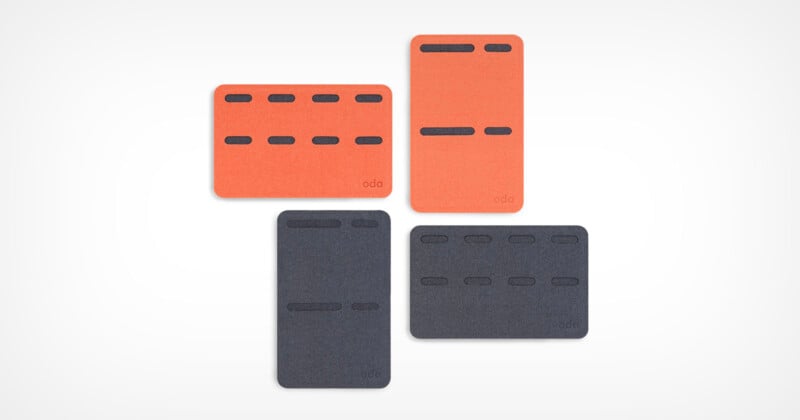 Four rectangular cards, two orange and two dark gray, are arranged against a light background. Each card has a series of black horizontal slots arranged in a pattern.