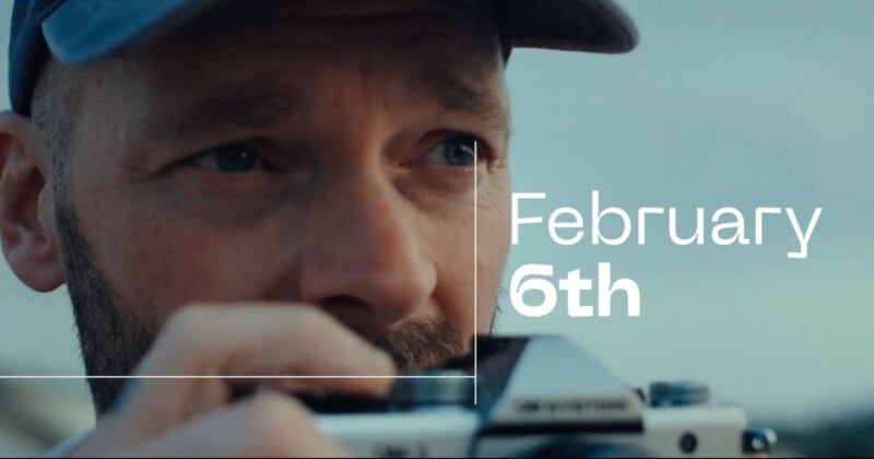 A person wearing a cap holds a camera up to their face, looking focused. The text "February 6th" is displayed prominently on the right side of the image.