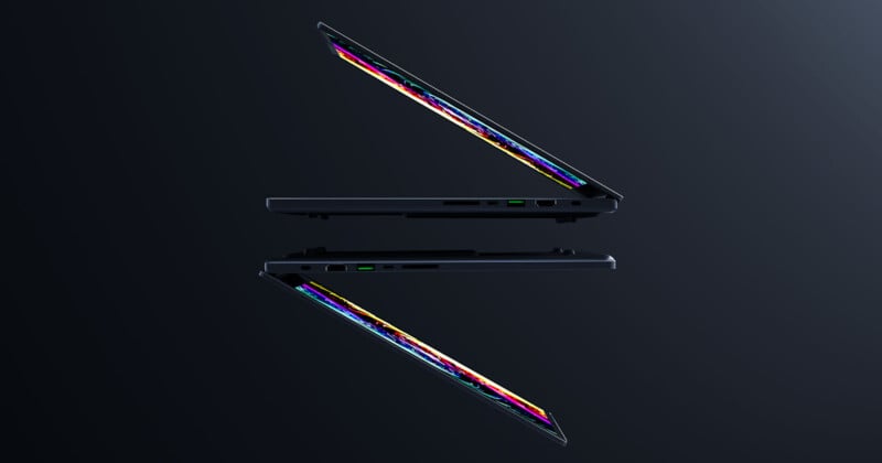 Two sleek, partially closed laptops with colorful screens floating against a dark background, mirrored to create a symmetrical effect. The laptops are positioned at a slight angle, showcasing their thin design and modern technology.