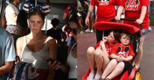 A woman with star-spangled Minnie Mouse ears sits on a bus looking at her phone. Next to her, two children in a stroller wear matching red Mickey Mouse family shirts, alongside adults wearing similar themed shirts.