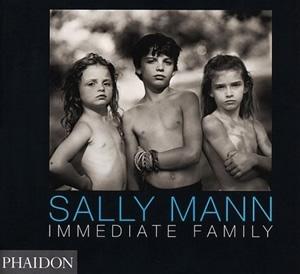 Black and white image featuring three children standing outside, all gazing toward the camera. This photo serves as the cover for the book "Immediate Family" by Sally Mann, published by Phaidon.