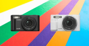 Two cameras are displayed against a colorful geometric background. The left camera is black and labeled "Yashica City 100," while the right camera is white and labeled "Yashica City 200." The background features diagonal stripes in bright colors.