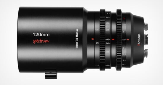 A 7Artisans 120mm T2.9 Macro 2x cinema lens is shown against a white background. The lens has visible focusing and aperture rings with distance markers and is designed for macro photography.