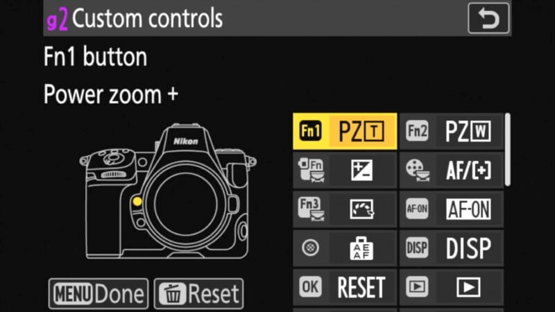 Camera menu screen showing custom controls. The Fn1 button is set to Power zoom +. Icons are displayed: Fn1, PZT, Fn2, among others. Options include OK, RESET, and Done. A camera illustration is on the left.