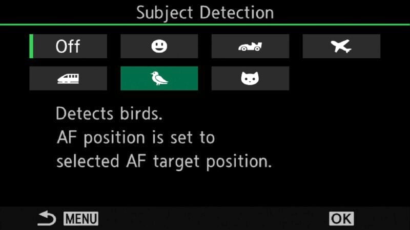 Camera subject detection settings menu. Options include turning detection off, or choosing people, vehicles, airplanes, trains, birds, or cats. Birds detection is highlighted. Text indicates AF position setting details. Menu buttons at bottom.