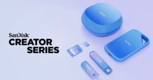 A collection of SanDisk storage devices, titled "Creator Series," displayed on a light purple surface. Includes two USB drives, an external hard drive, a microSD card, adapter, and wireless charging pad, all in blue. SanDisk logo visible on each item.