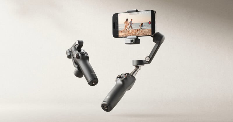 A smartphone mounted on a DJI Osmo Mobile 6 gimbal setup is suspended in mid-air. The phone displays a video recording of people running on a beach. They are against a neutral background, highlighting the gimbal's stabilizing capabilities.