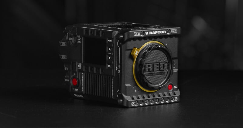 A black and yellow high-end professional camera body with the branding "V-RAPTOR." It features detailed buttons and controls, and is set on a dark surface with a black background, emphasizing its sleek design and modern technology.