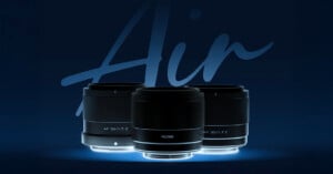 Three camera lenses are displayed against a dark blue background with the word "Air" partially visible behind them. The lenses are black with silver accents and are labeled 56/1.7, 23/1.4, and 35/1.7, with "Viltrox" written on the middle lens.