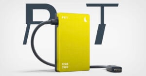 A yellow PKT SSD 2GO with a braided USB cable is displayed in front of large overlapping letters "P" and "T" on a white background.