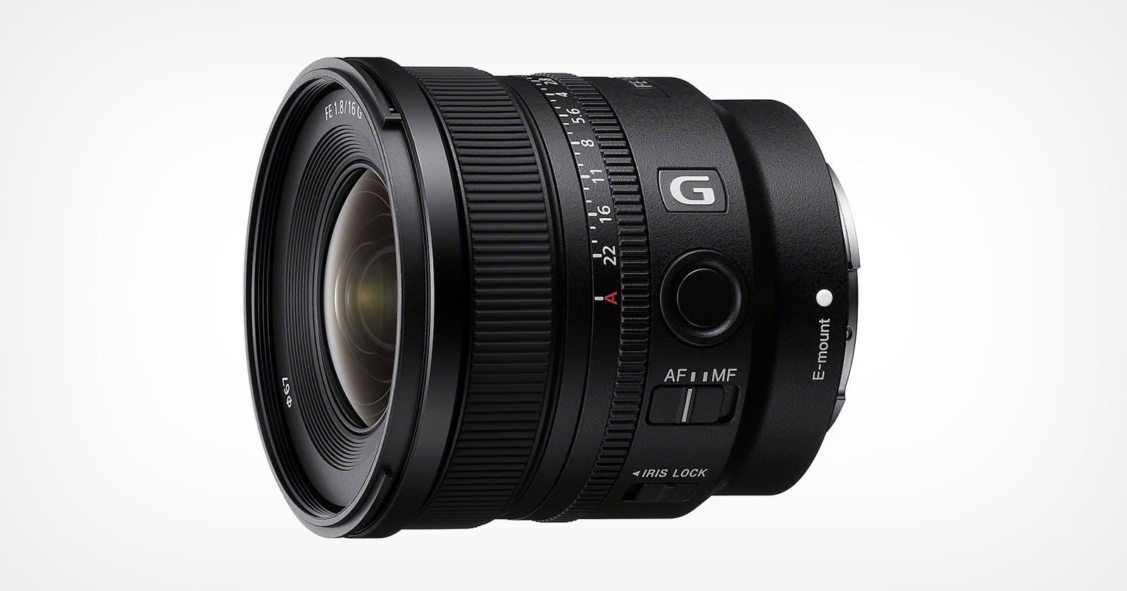 Close-up of a black camera lens with a wide aperture. The lens features adjustment rings for focus and aperture, and has various labels and markings, including a G symbol and E-mount label. The lens is set against a plain white background.