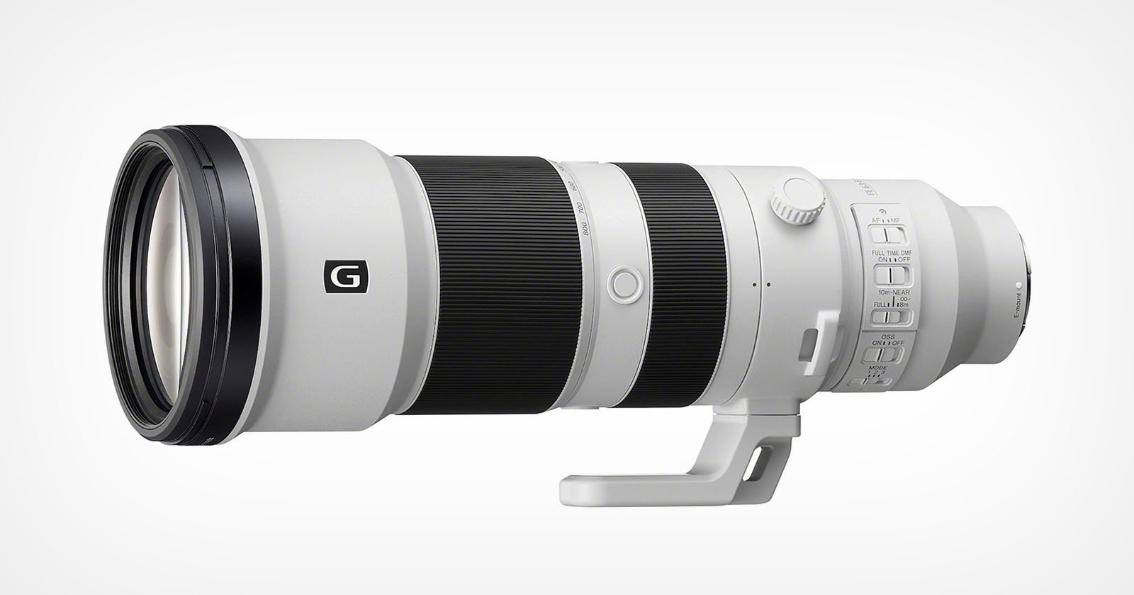 A white and black telephoto camera lens with a tripod mount is displayed against a light gray background. The lens features labeled controls and a "G" logo near its base.