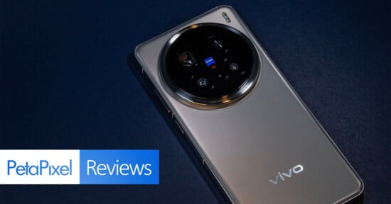 Smartphone with a large circular camera module on a dark surface. The phone has a metallic finish and displays the brand "vivo." PetaPixel Reviews logo is visible in the bottom left corner.