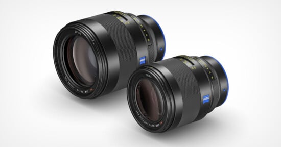 Two black camera lenses with blue accents are displayed against a white background. The lenses are marked with specifications and branding, featuring a sleek, modern design. One lens is larger than the other, both positioned at a slight angle.