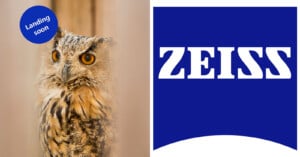 An owl with vivid orange eyes and detailed plumage on the left, partially framed by blurry bars. On the right, a large blue square with the text "ZEISS" in bold white letters. A blue circle with "Landing soon" is on the top left corner.