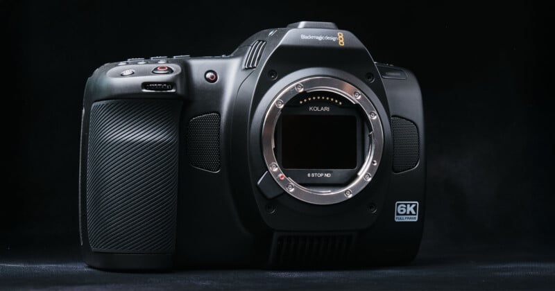 A Blackmagic Pocket Cinema Camera 6K is displayed against a dark background. The camera's body is shown without a lens, revealing the sensor. The brand and model are visible on the camera's top.