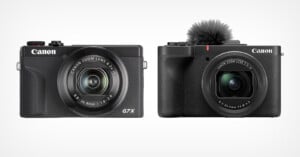 Two Canon compact cameras side by side on a white background. The left camera is labeled "G7 X" with a visible zoom lens. The right camera has a small microphone attachment on top. Both cameras have a classic black finish.