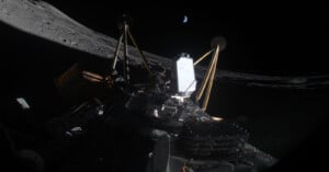 A spacecraft is visible on the moon's surface, with its structure highlighted against the dark sky. The Earth appears as a small crescent in the distant background. Shadows and the moon's rugged terrain are prominent.