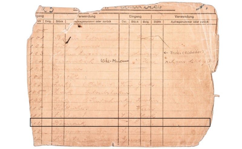 A torn, aged document with handwritten notes and printed German headings such as "Verwendung" and "Eingang." The paper shows wear and discoloration, with illegible text due to fading and damage.