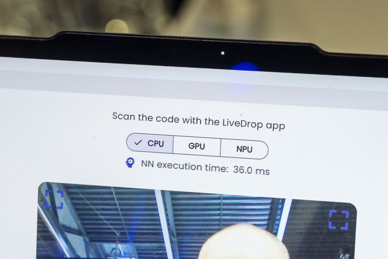 Close-up of a tablet screen showing a software interface. Text above reads "Scan the code with the LiveDrop app." Buttons for CPU, GPU, and NPU selection are visible. Below, text indicates "NN execution time: 36.0 ms." A partial image is at the bottom.